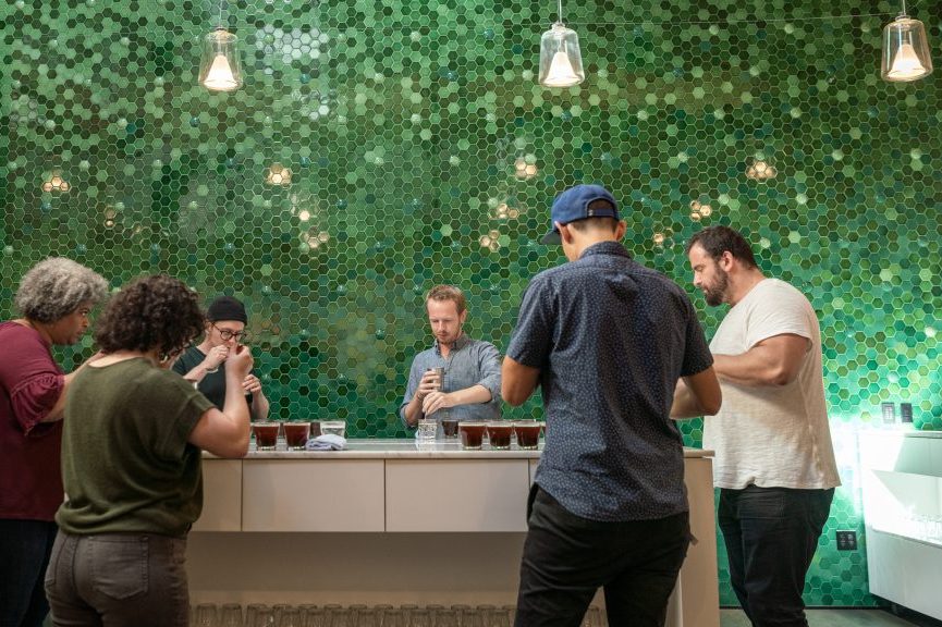 People gathered around a counter in a café