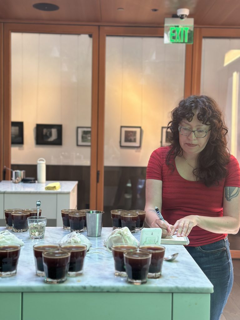 Caitlin taking coffee taste notes