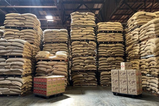 Coffee warehouse with stack of coffee bags