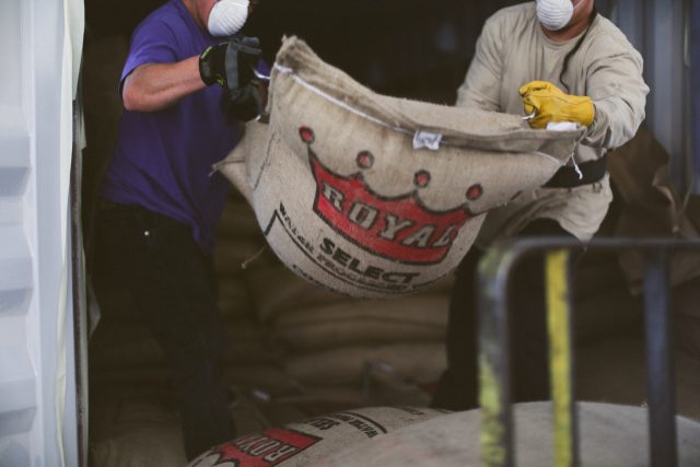 royal coffee warehouse green coffee bag unloading 